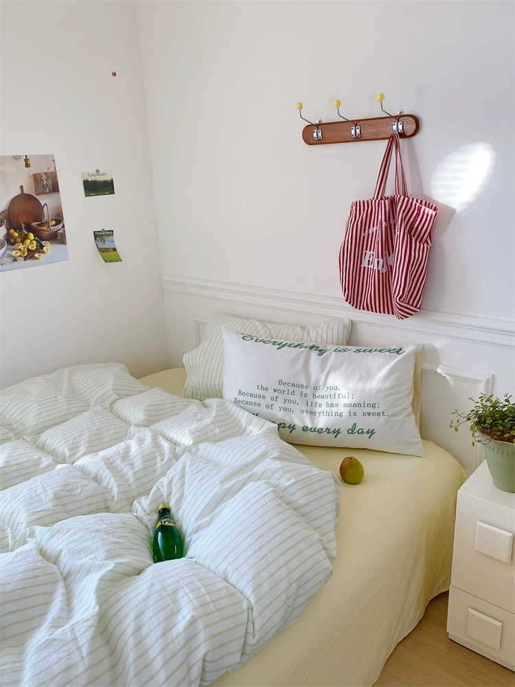 Small bedroom with a bed, pillows, and a nightstand.