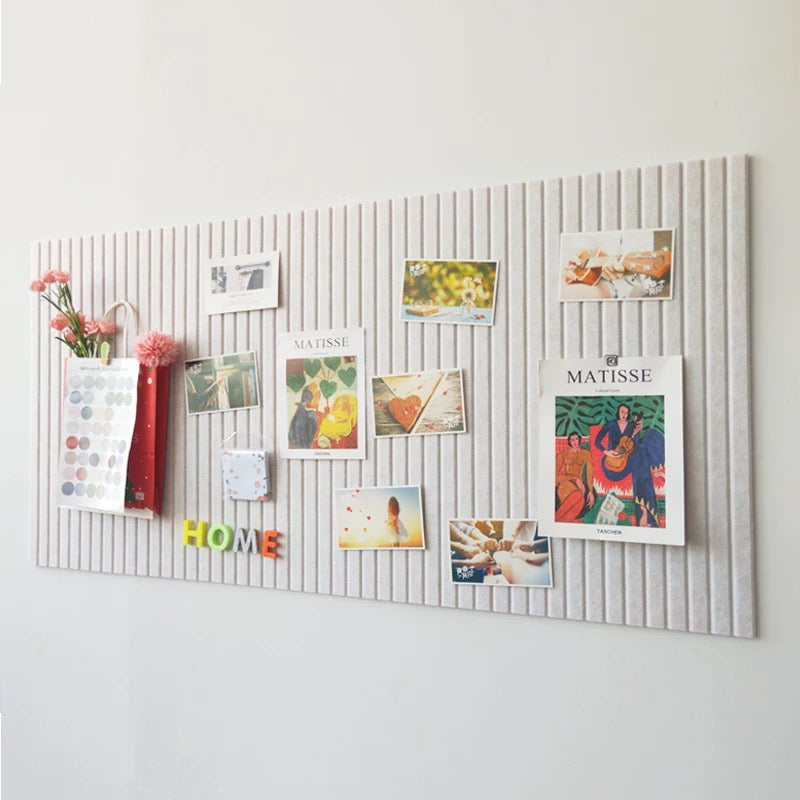 Decorative wall panel with pinned photos and notes on a light gray background