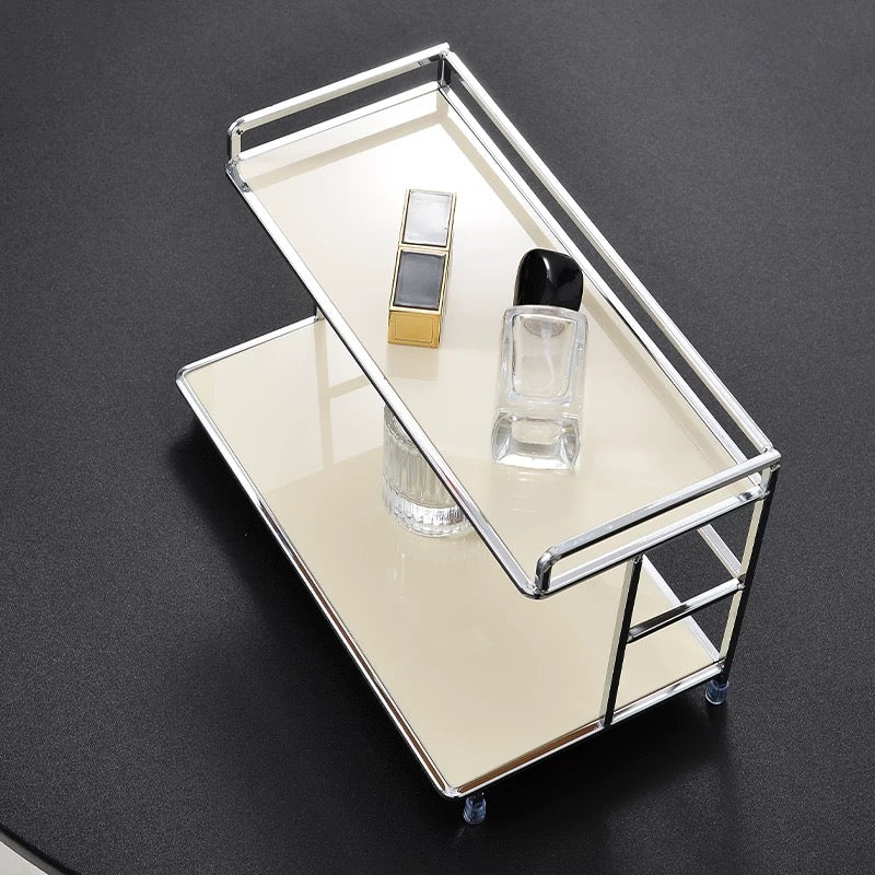 Small mirrored cart with cosmetic items on a dark background