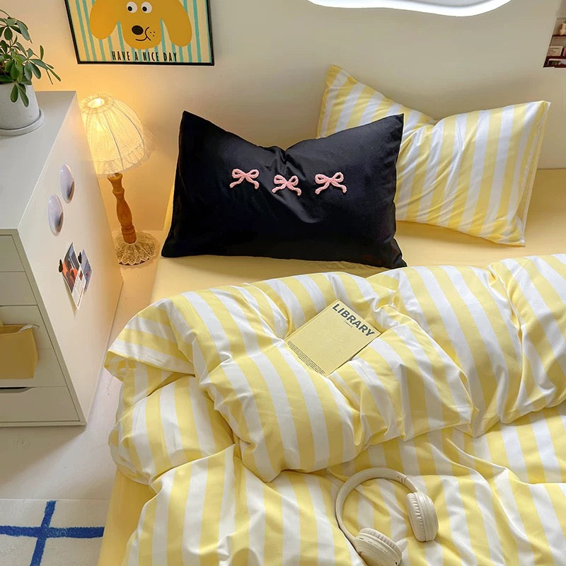Dorm room makeover showcasing the transformation using the yellow striped bedding set.