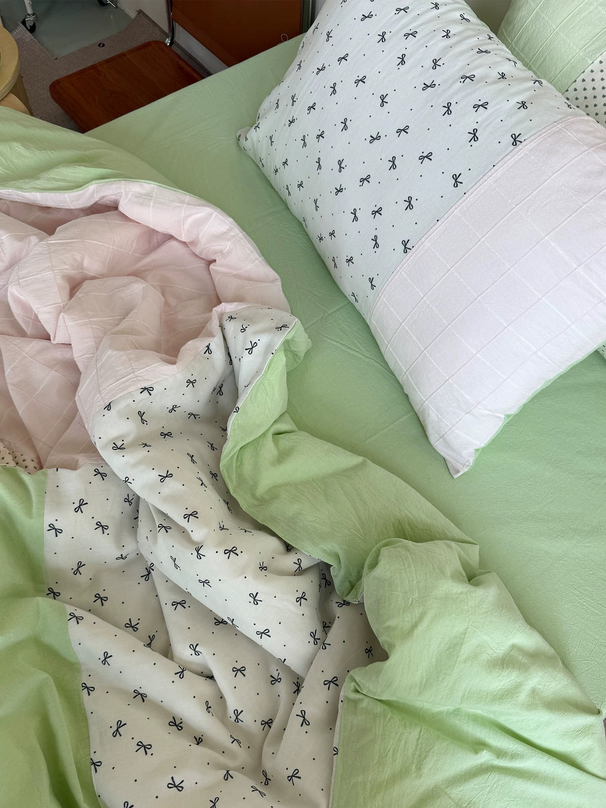 Detail of mint green cotton fabric beside a white printed panel