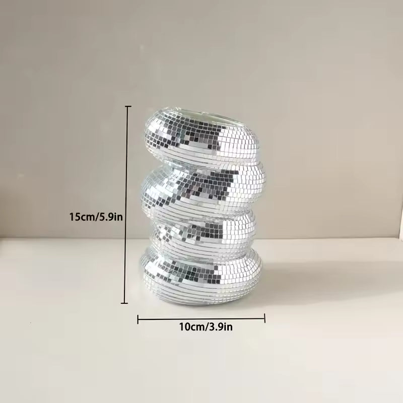 Silver disco ball with dimensions on a neutral background