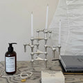 The candlestick on a mantelpiece, complementing minimalist décor.