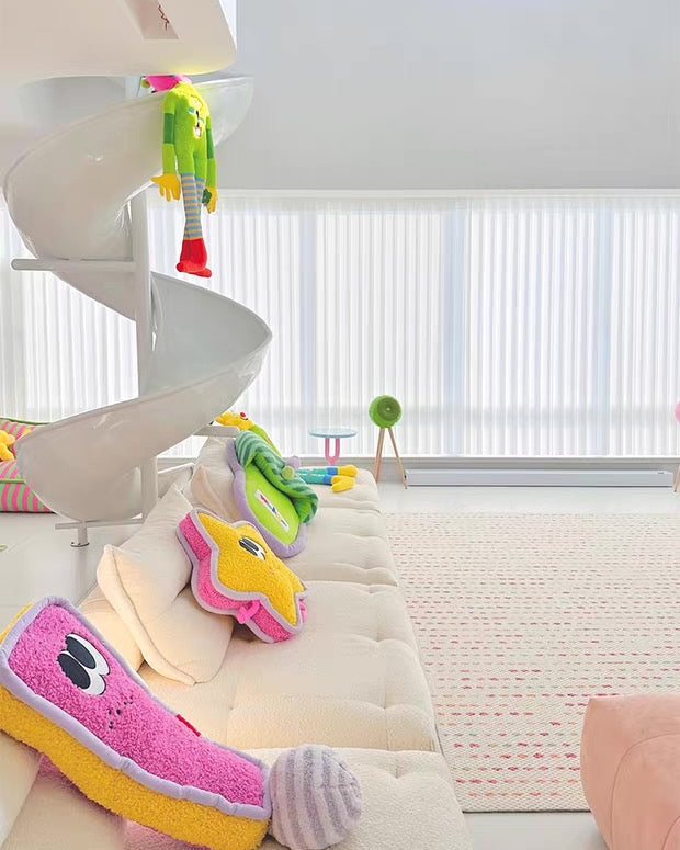 Colorful dog toys hanging on a spiral staircase in a modern living room.