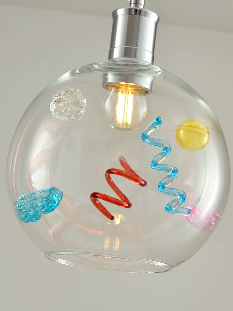 Decorative light bulb with colorful spiral designs inside a clear glass sphere.