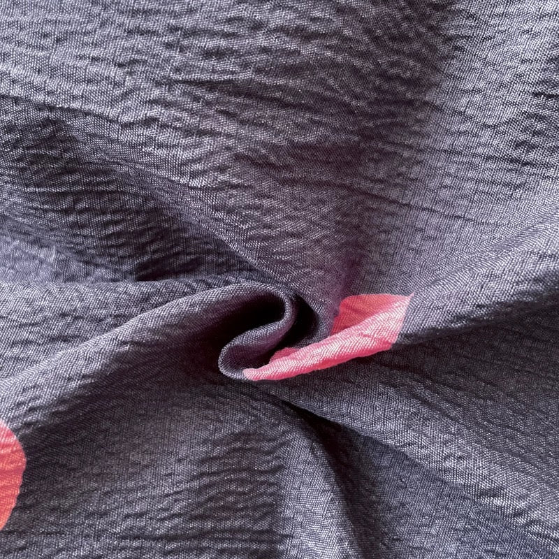 Dark gray polka dot bedding paired with colorful pillows for playful teen bedroom decor