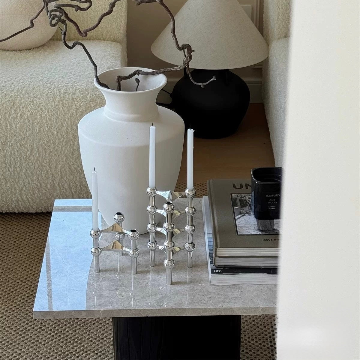 The candle holder placed on a modern dining table, adding a touch of elegance.