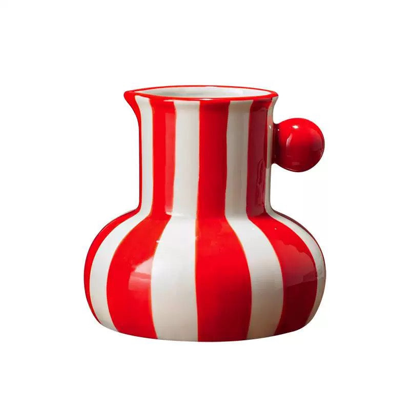 Red and white striped pitcher on a white background