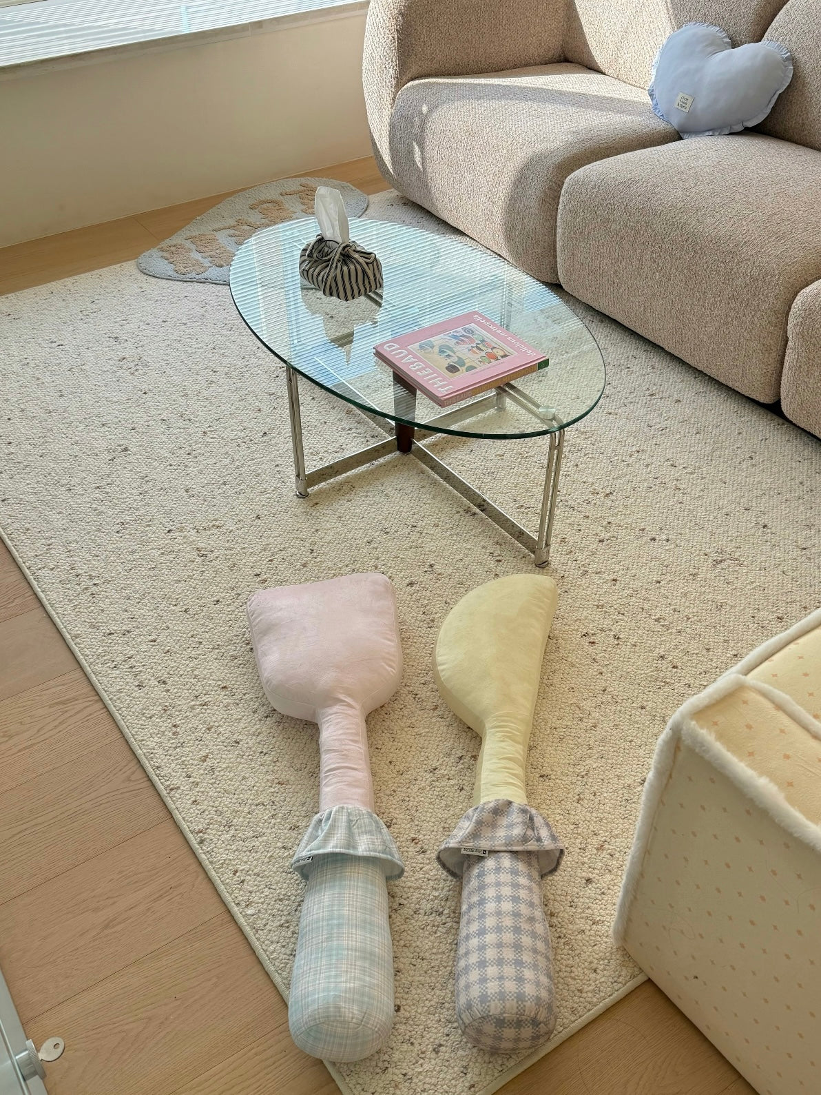Pink spatula and yellow knife novelty pillow designs lie side by side with their patterned handles aligned.