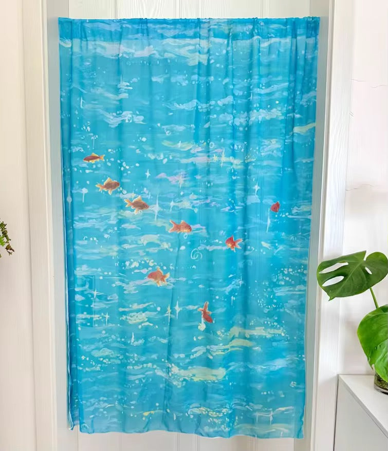Blue curtain with fish pattern in a room setting