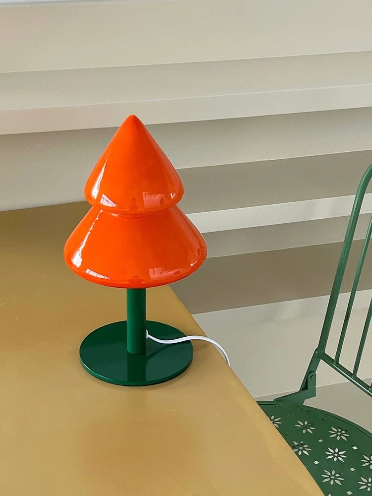 Orange Christmas tree night lamp with green base on a tabletop