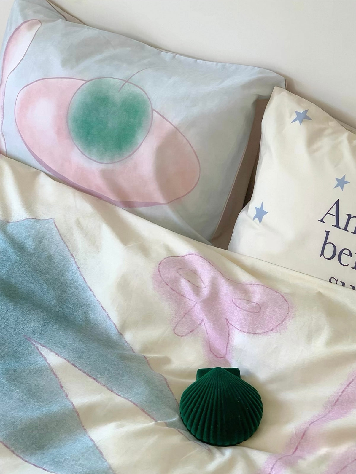 Close view of a pastel pillowcase with a green fruit shape on a pink plate.