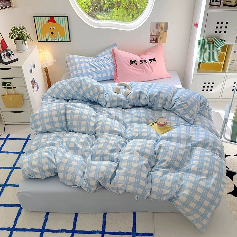 Close-up of the pastel blue plaid bedding set featuring breathable cotton fabric and cozy texture