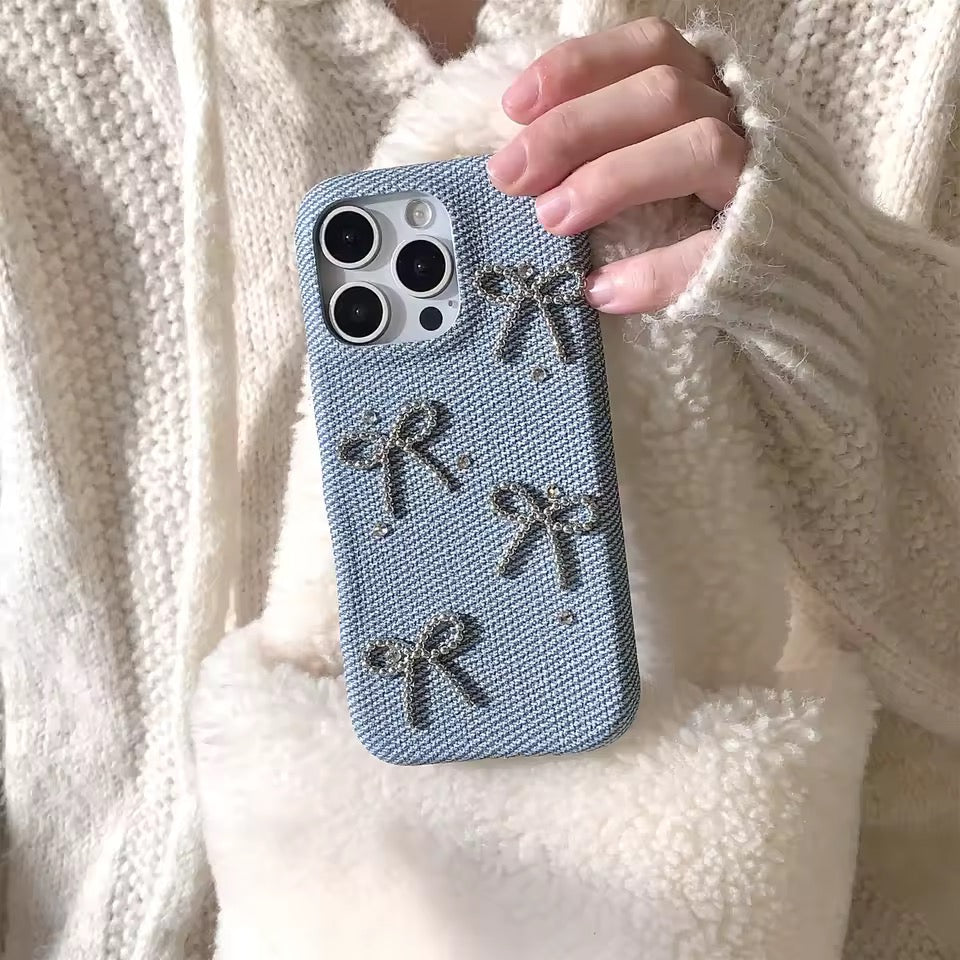 Person holding a phone case with bow designs against a neutral background