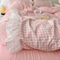 Pink bow decor and gingham bedding styled for soft girl dorm room