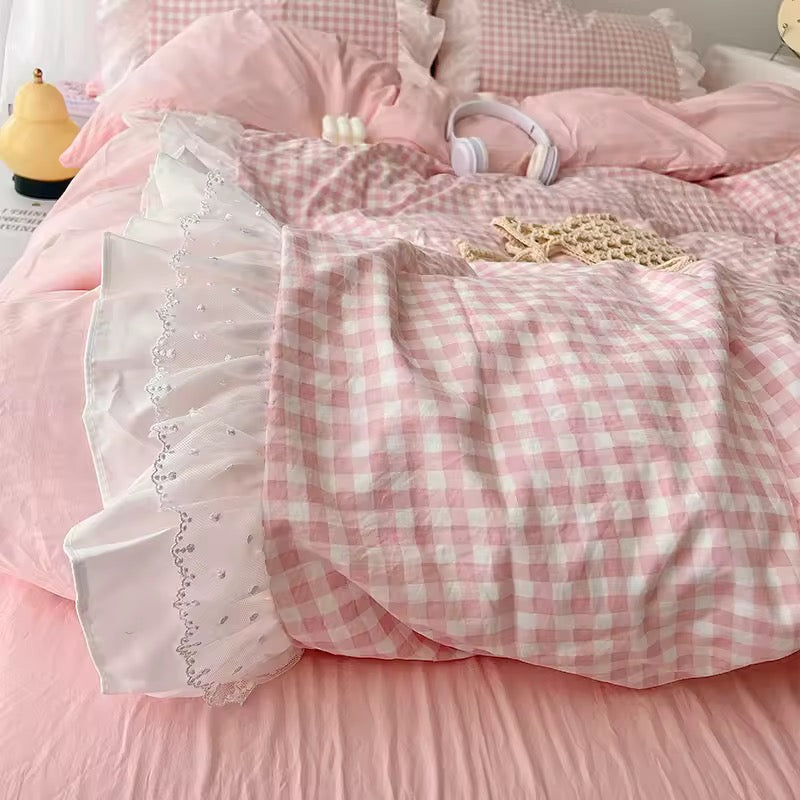 Pink bow decor and gingham bedding styled for soft girl dorm room