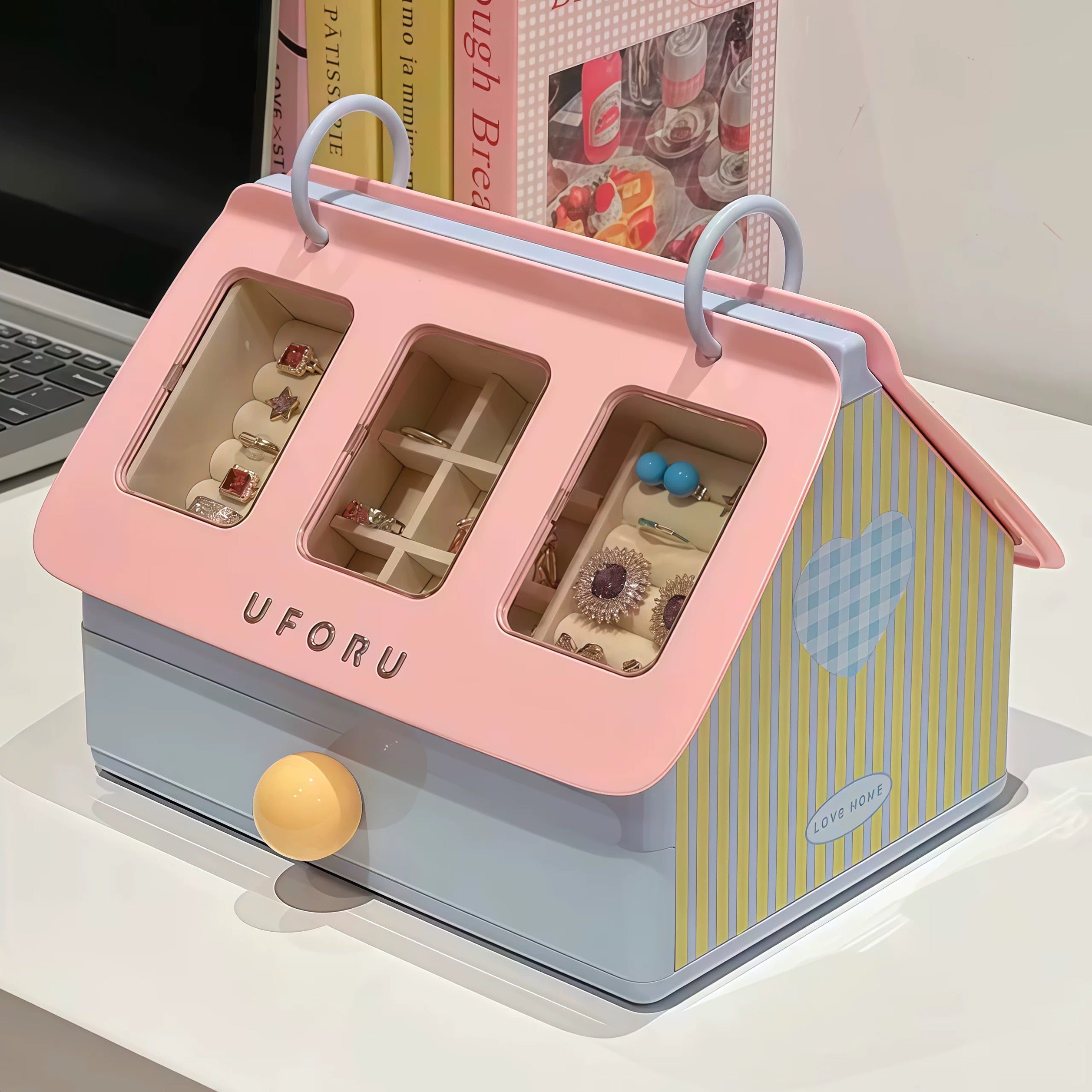 Pink and blue jewelry box with 'UFORU' branding on a white surface.