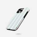 The Hey Girly x The Feelz striped case resting on a pastel blanket, adding soft Korean‑minimalist vibes.