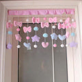 Dorm room doorway decorated with kawaii pink curtain divider.
