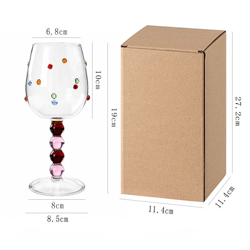 Pink champagne glass with raised colorful dots, ball stem and product dimensions