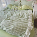 All three pastel gingham bedding options styled together: pink, green, and blue