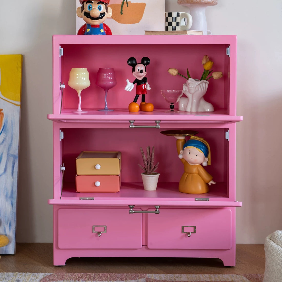 Pink dopamine display cabinet used as playful storage sideboard in pastel aesthetic interior room design