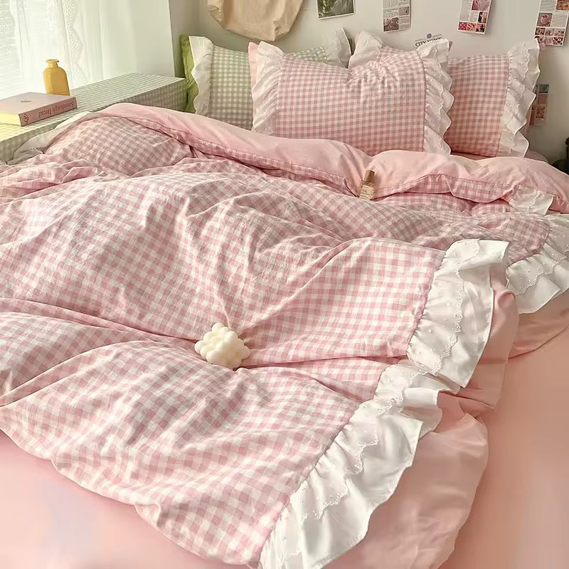 Pink gingham duvet with lace trim on a pastel pink bed