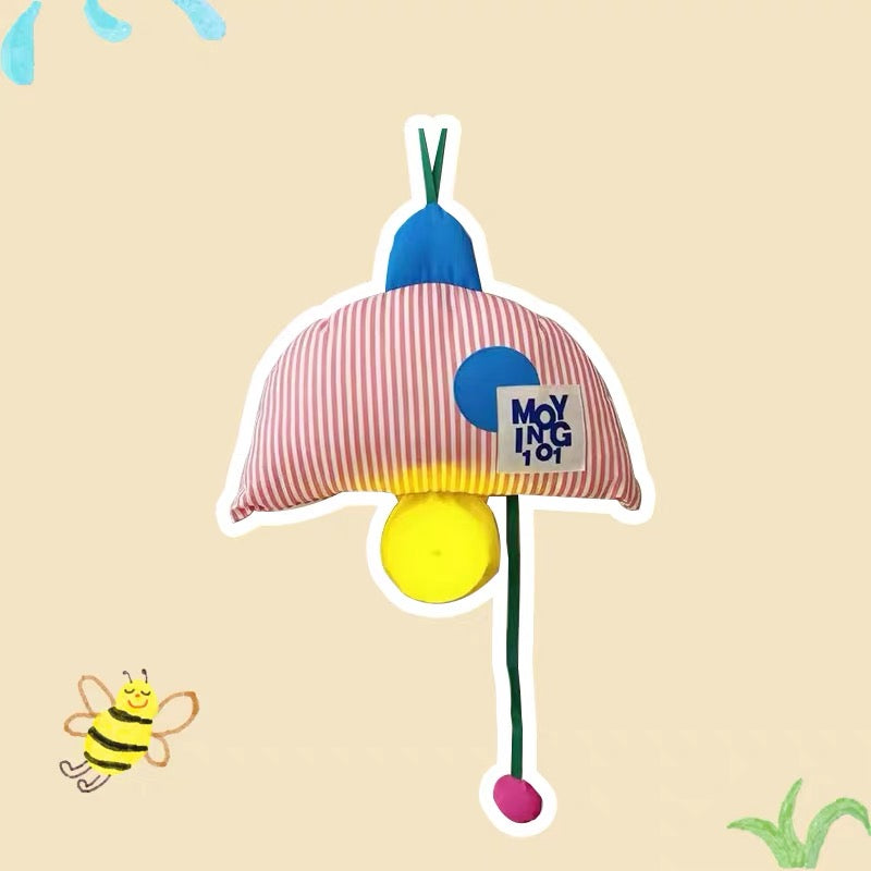Colorful cat toy with striped pink umbrella and blue and yellow accents hanging on a hook.