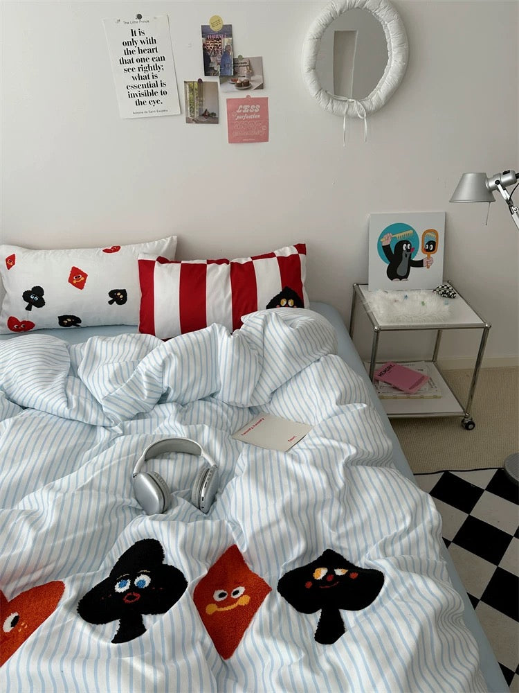 Soft cartoon bedding set with stripes and card icons, ideal for kawaii bedroom decor and Pinterest-inspired spaces.