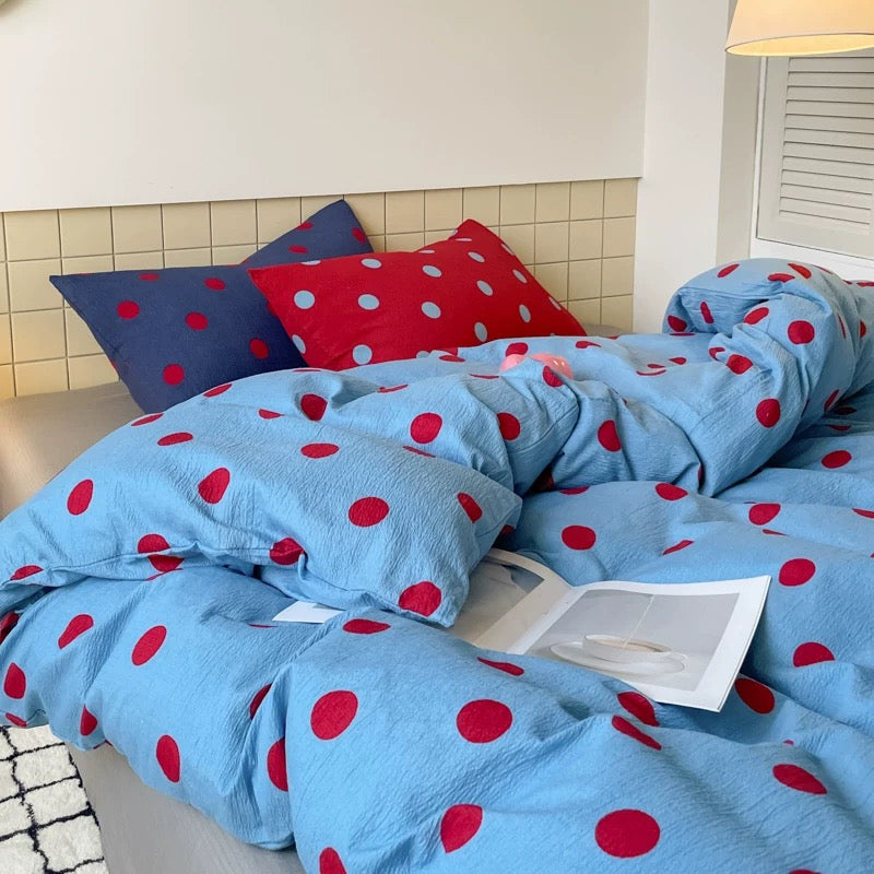 Blue and red polka dot bedding set photographed on a full size bed for cozy everyday bedroom comfort.