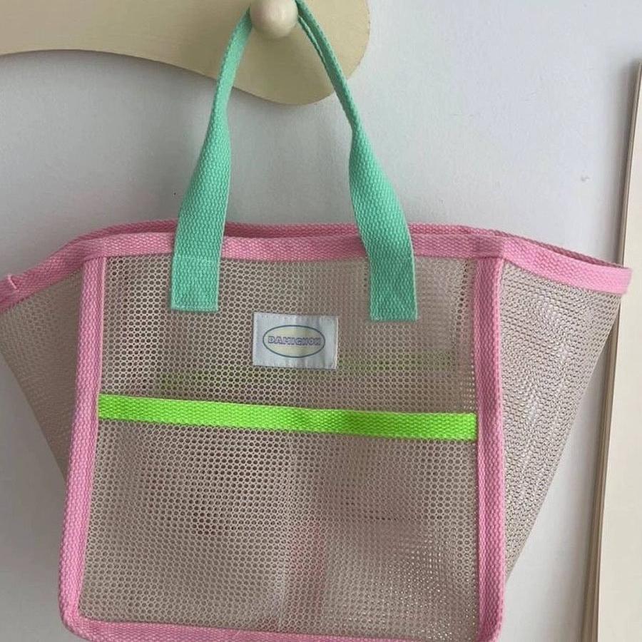 Transparent pink mesh bag for poolside and beach use