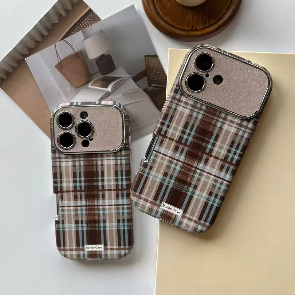 Plaid patterned phone case on a surface with a blurred background