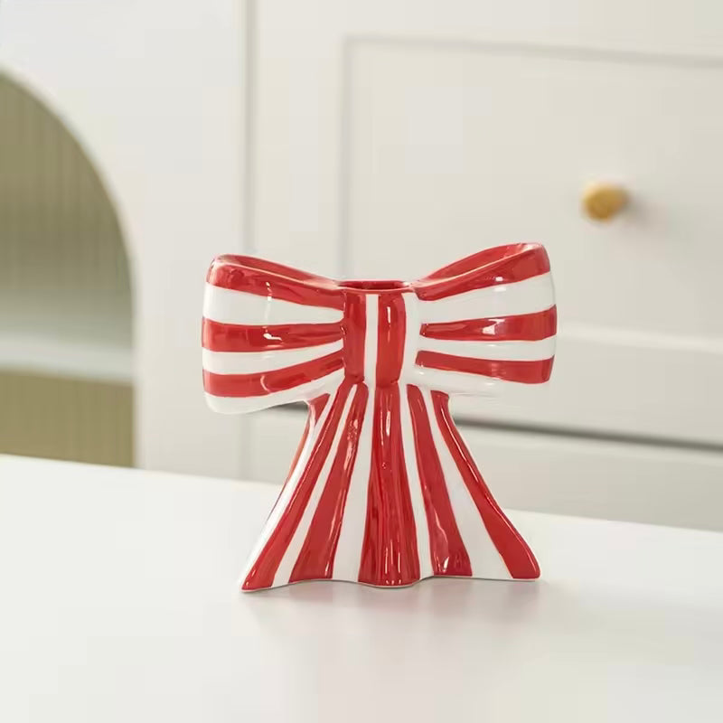 Glossy ceramic bow candle holder on shelf home decor
