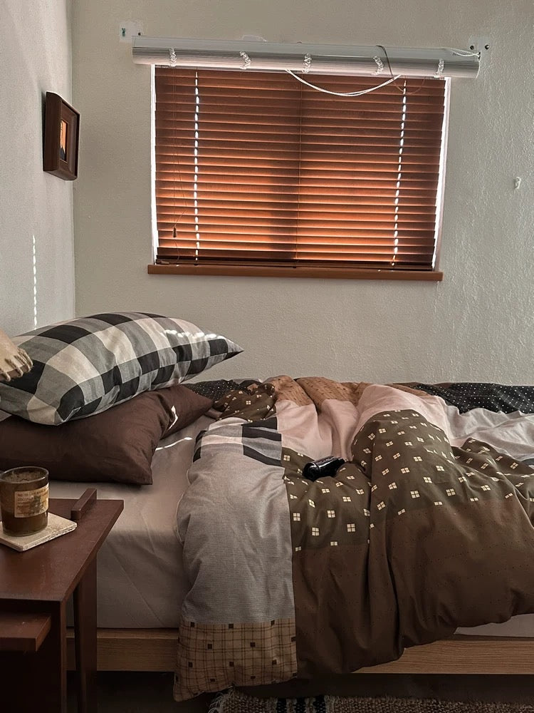 Preppy brown gingham duvet cover set styled with mixed checks and warm wood furniture