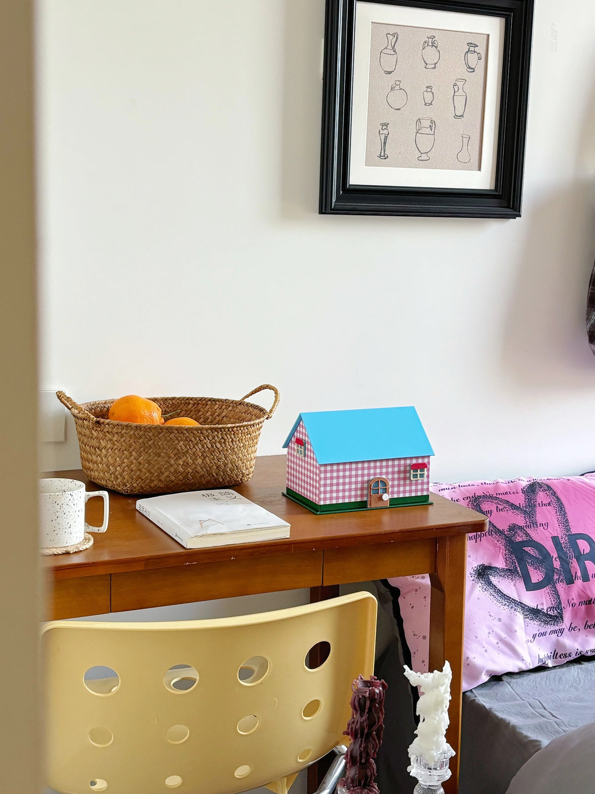 Pink gingham tissue box cover styled on a desk with chair and shelf