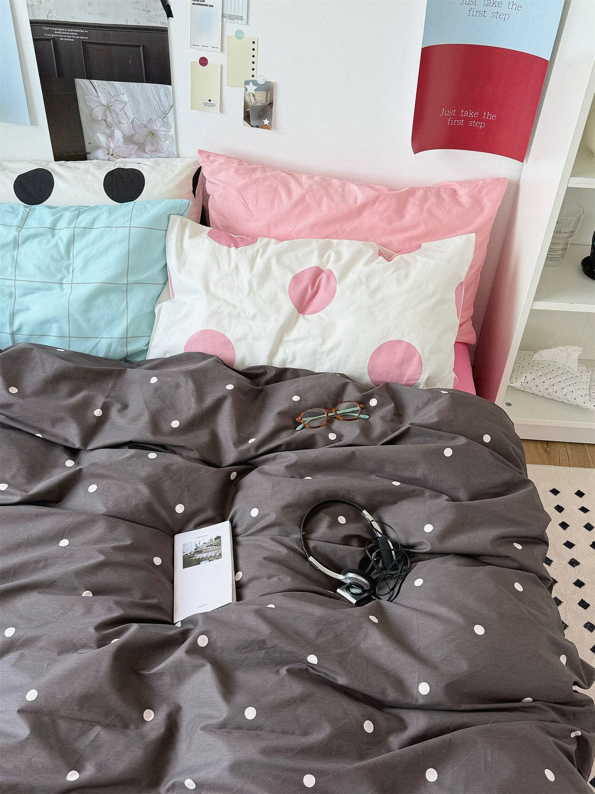Preppy pink polka dot bedding shown from the front with blue checks and large black and pink dots at the head.