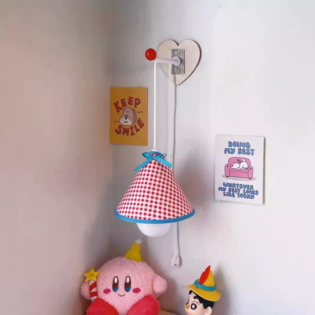 Children's room with a lamp, plush toys, and motivational posters on a white wall.