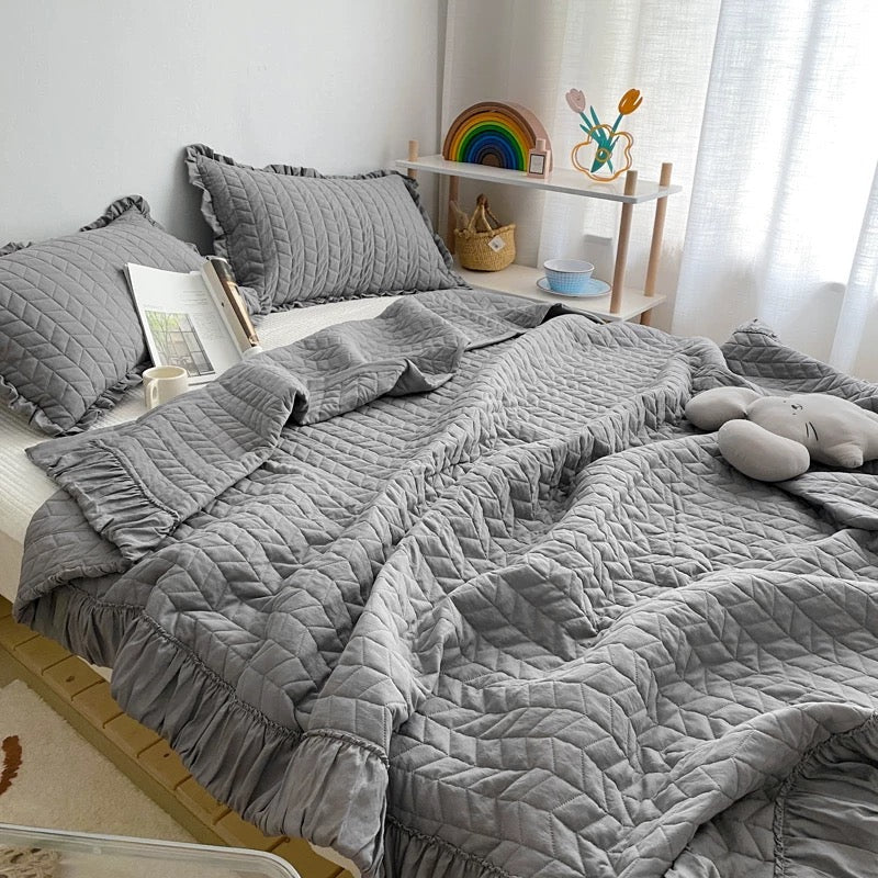 Quilted blanket with ruffles for a softly styled bedroom