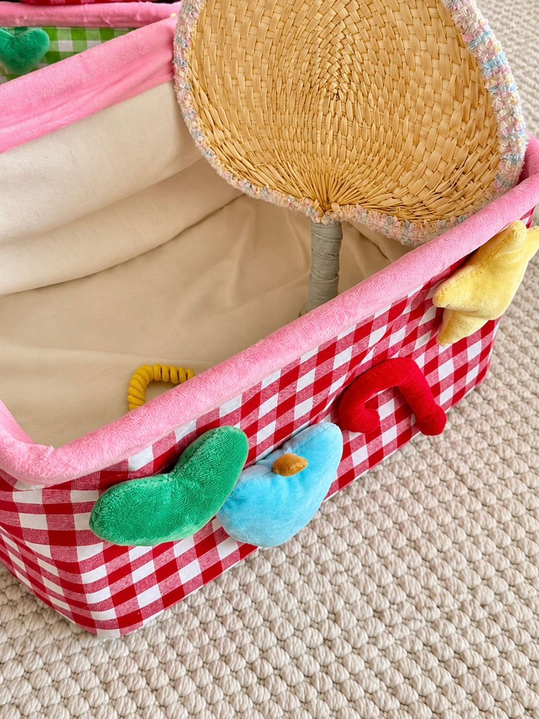 Red plaid storage basket with pink rim shown from the side