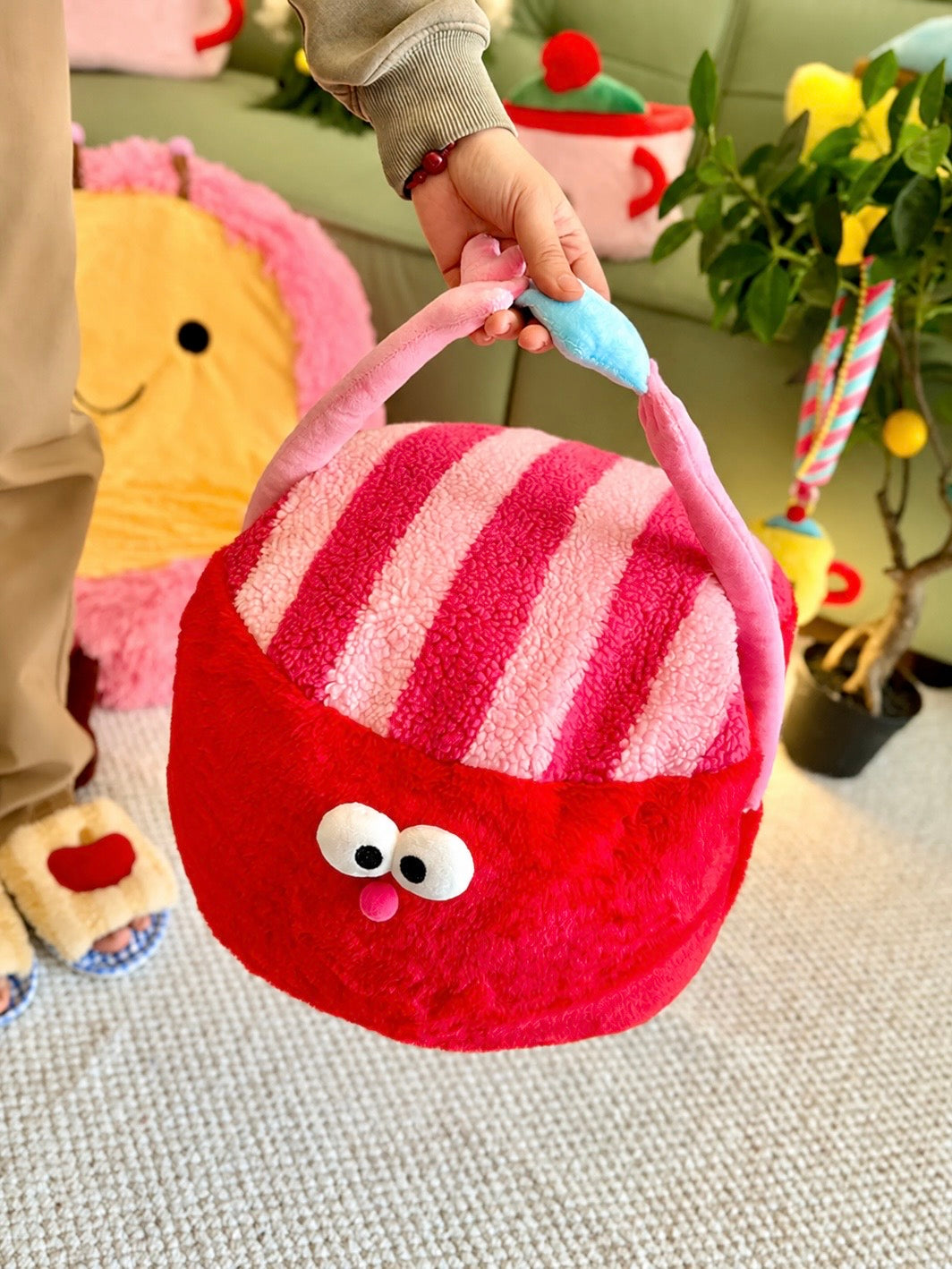 Red striped ottoman pouf with pink arms and blue heart detail