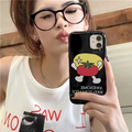 Person holding a phone with a black case featuring a cartoon design, wearing a white sleeveless shirt.