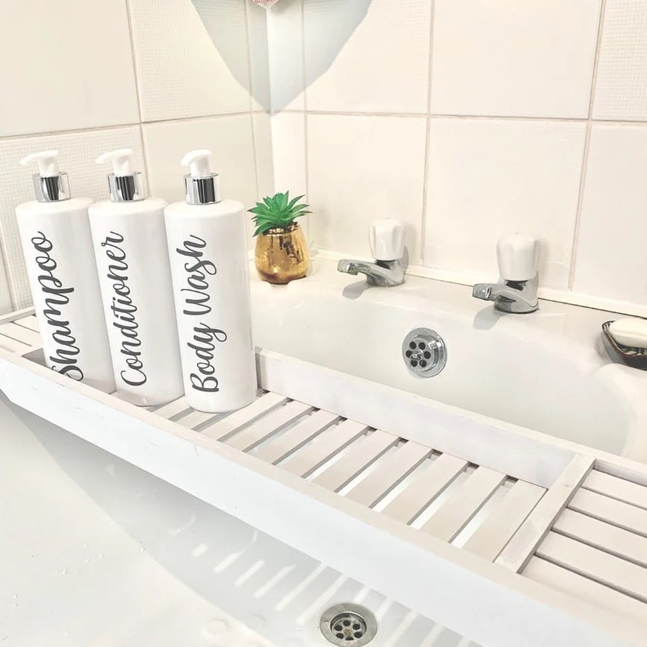 White bathroom dispenser set with 500ml refillable bottles for shampoo, conditioner, and lotion. Farmhouse decor with bamboo pump head design.