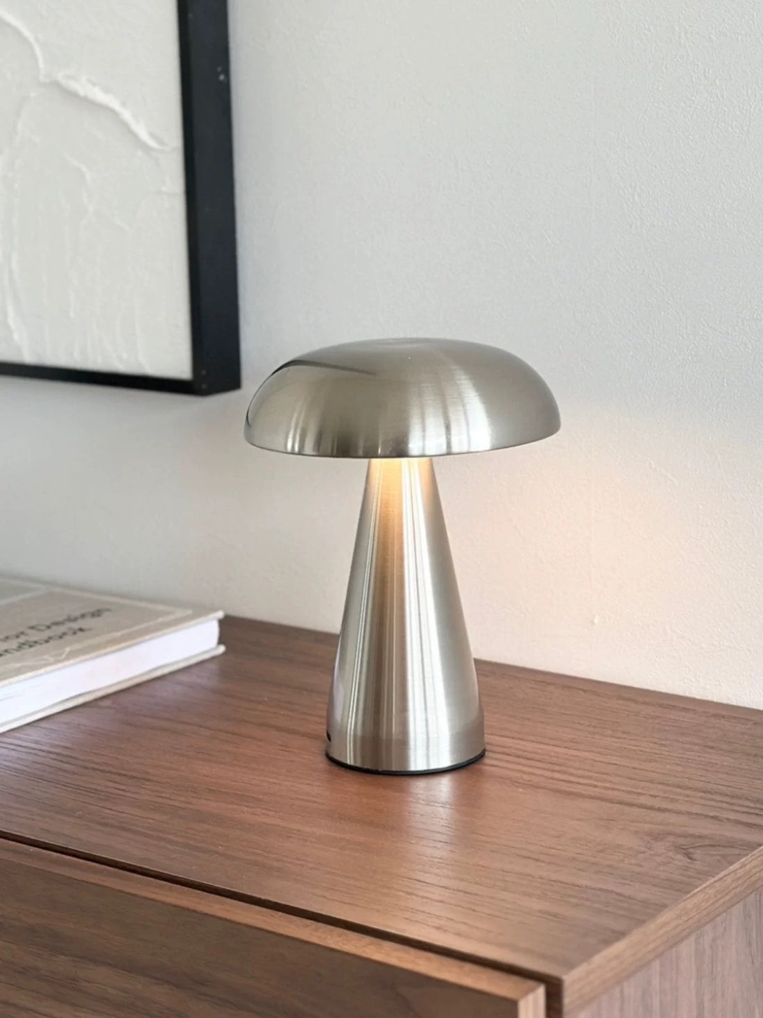 Silver Scandinavian LED lamp with touch control glowing softly