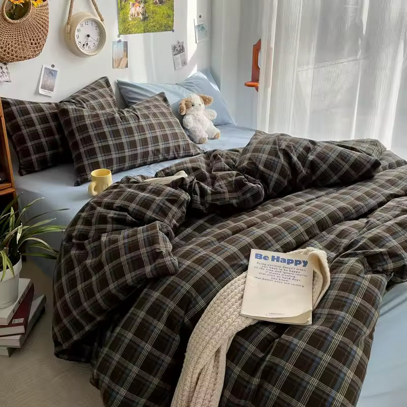 Bedroom with plaid bedding and decorative items on a bed