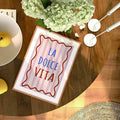 La Dolce Vita canvas art hanging in a pastel-themed dorm room, complementing the decor.