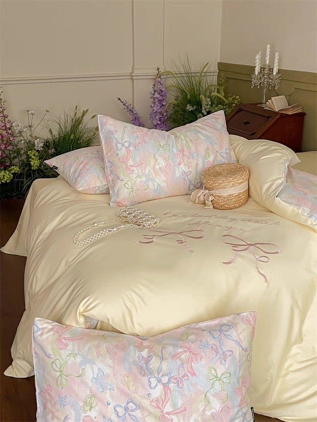 Bed with floral-patterned pillows and a decorative comforter in a bedroom setting.