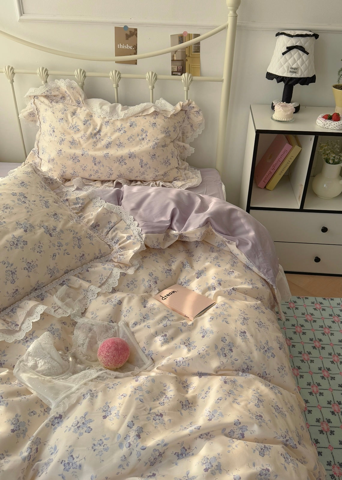 Floral bedding set on a bed with a nightstand in the background