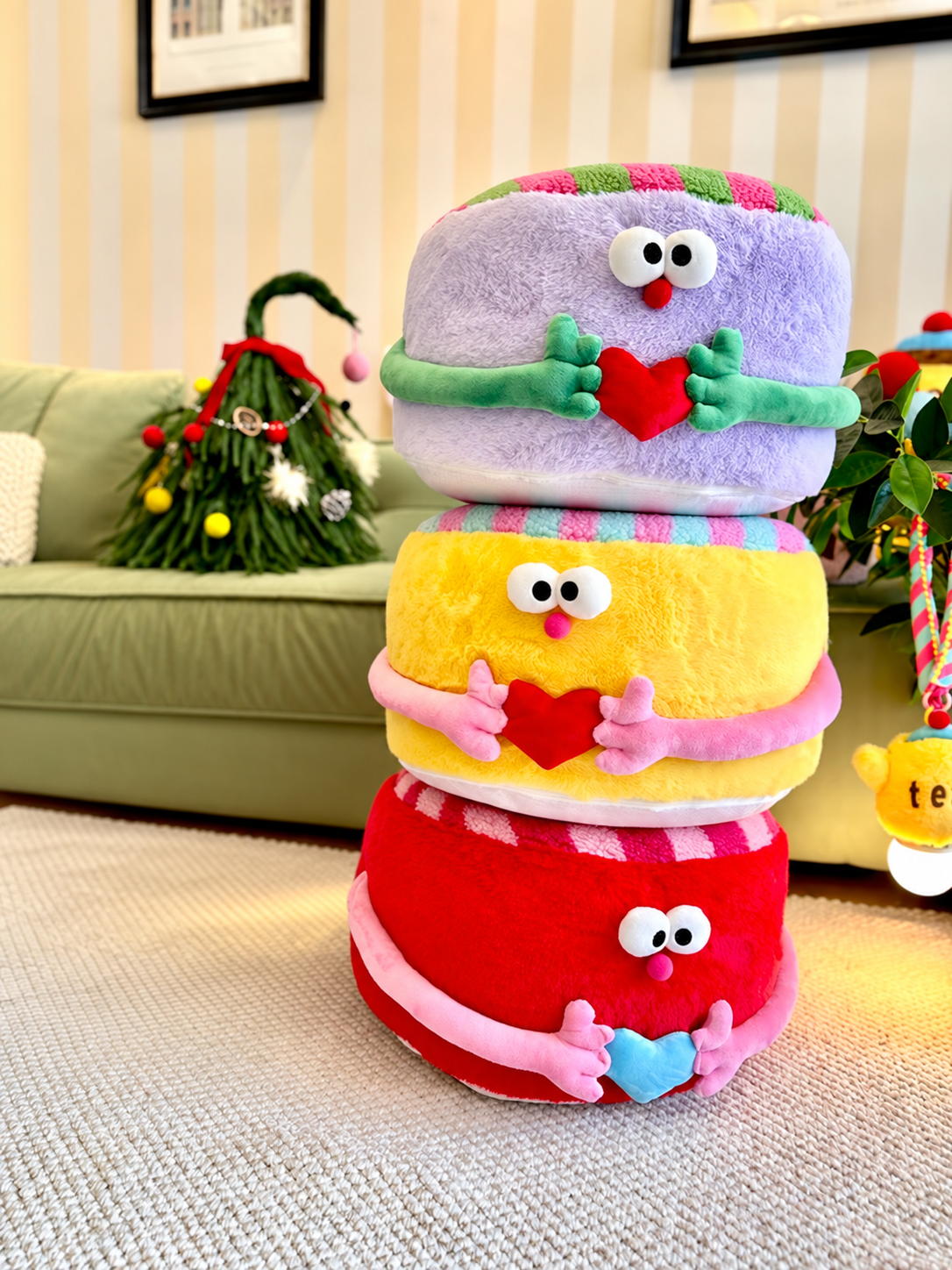 Round pouf ottomans stacked in purple, yellow, and red