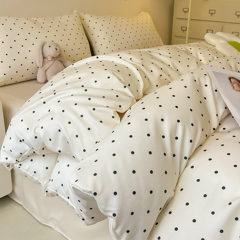 Minimalist black dot satin bedding set styled in a soft aesthetic bedroom.