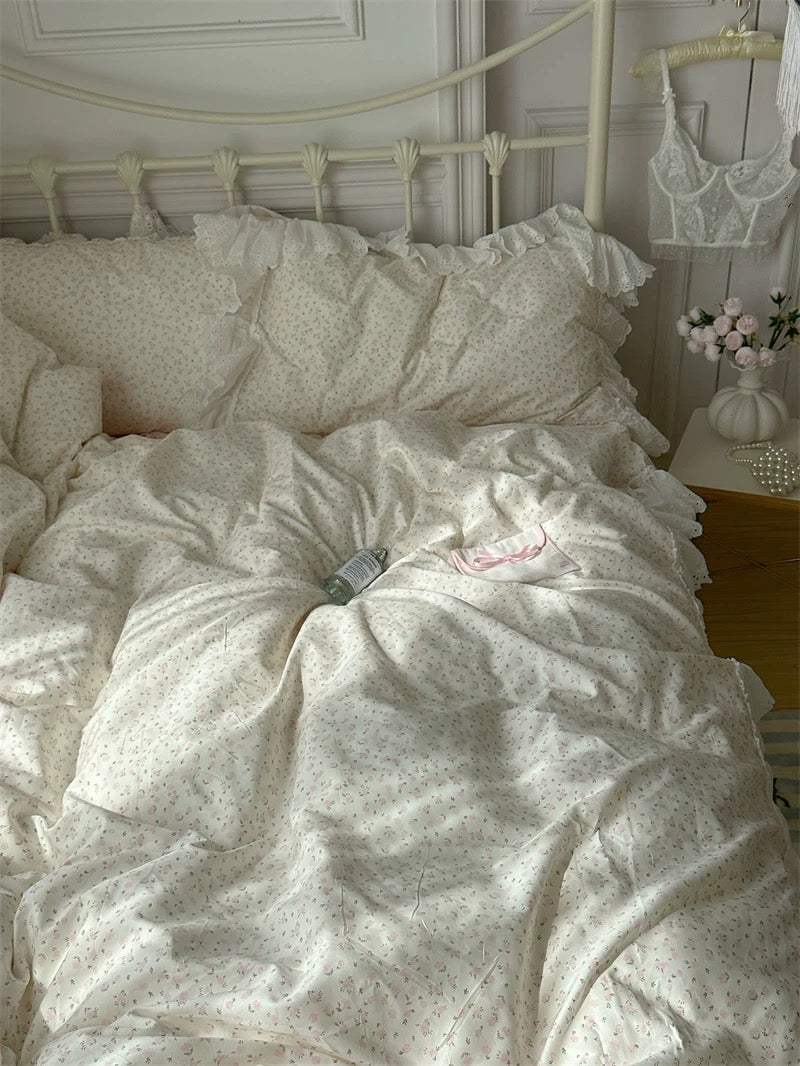 Neatly made bed with white bedding and pillows in a bedroom setting.